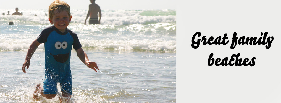 Family beach, child in surf